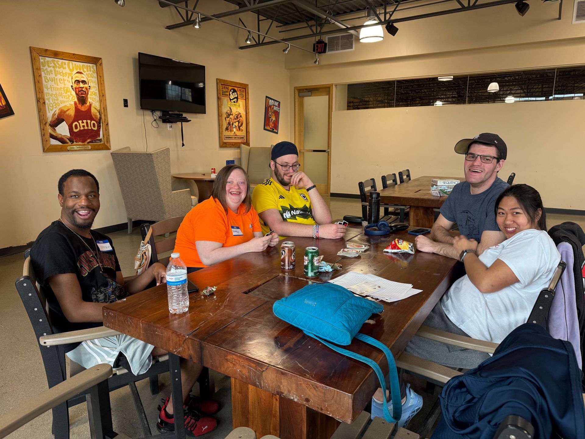 Short North Church. Four people seated at a restaurant table, smiling and eating in a casual dining area.