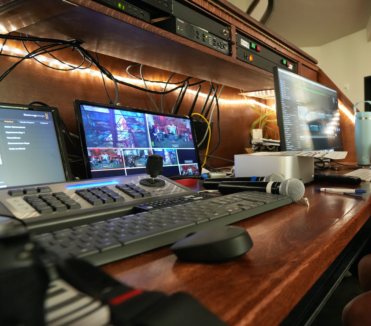 Short North Church. Church tech keyboard, monitor, audio gear, and tangled cables under warm lighting