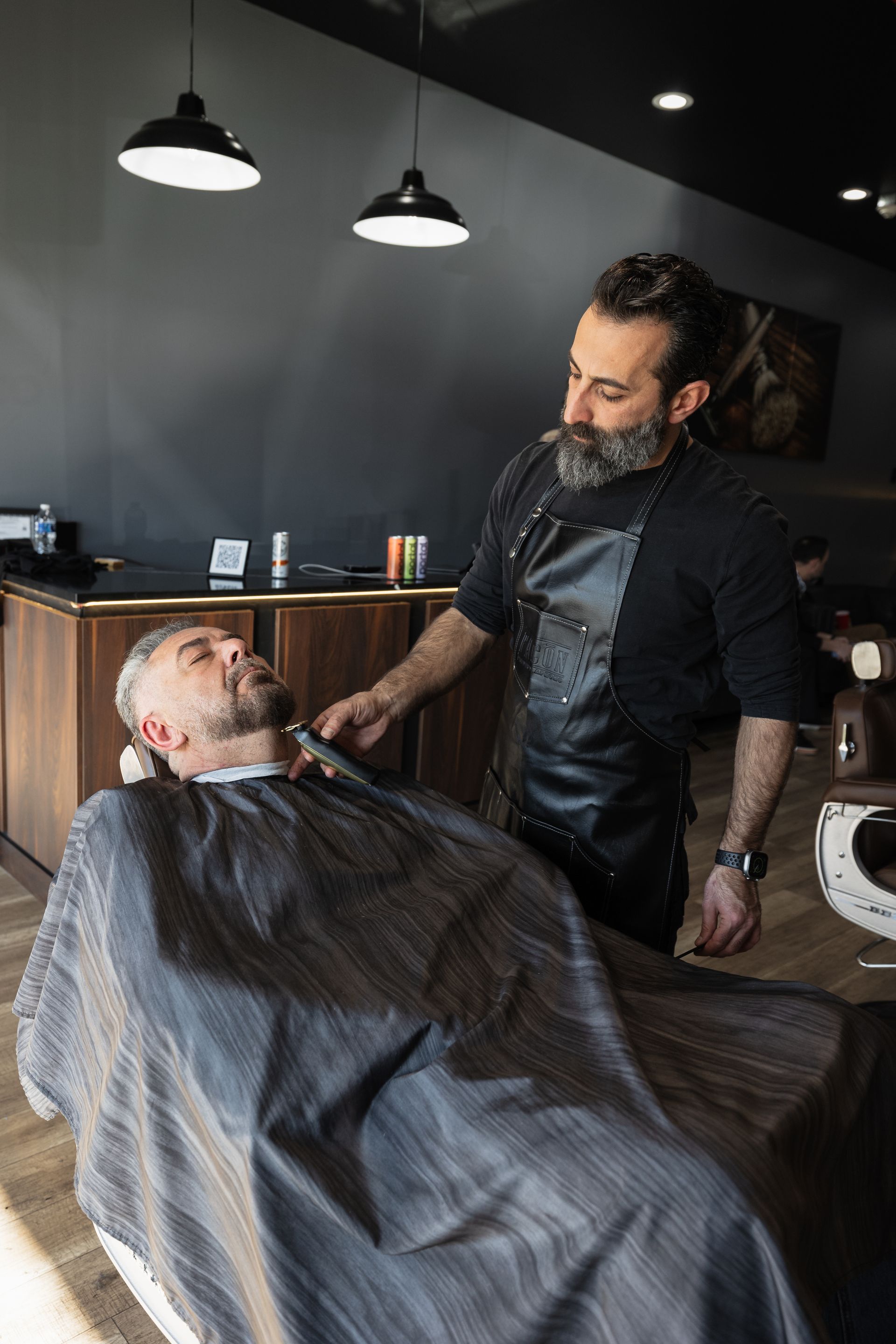a man with a beard is wearing a black shirt and looking at the camera .