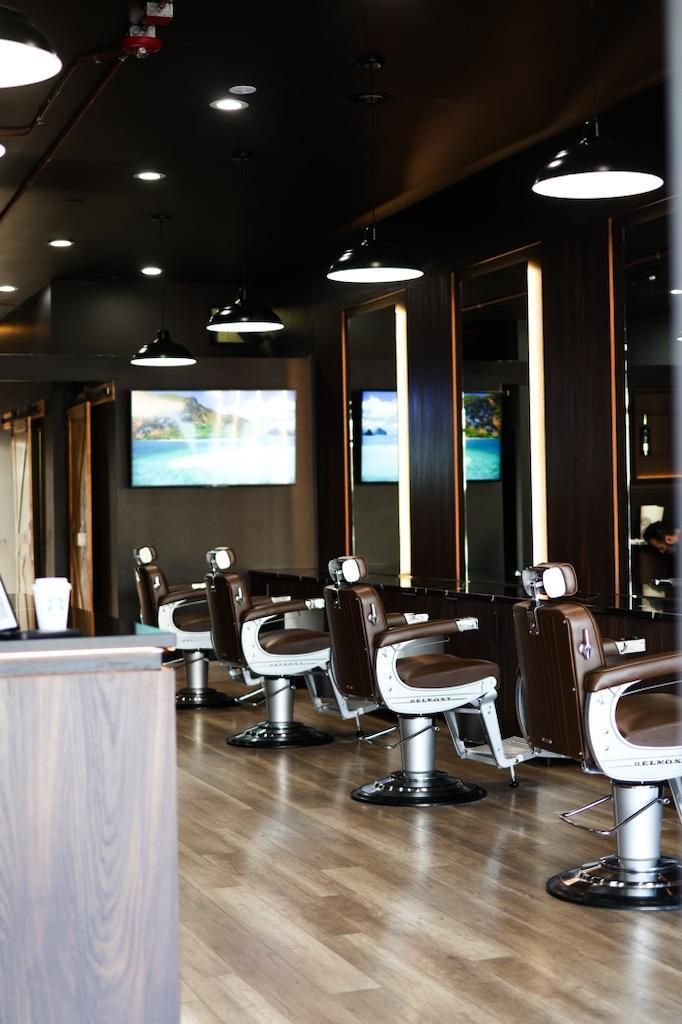 A barber shop with a lot of chairs and mirrors.