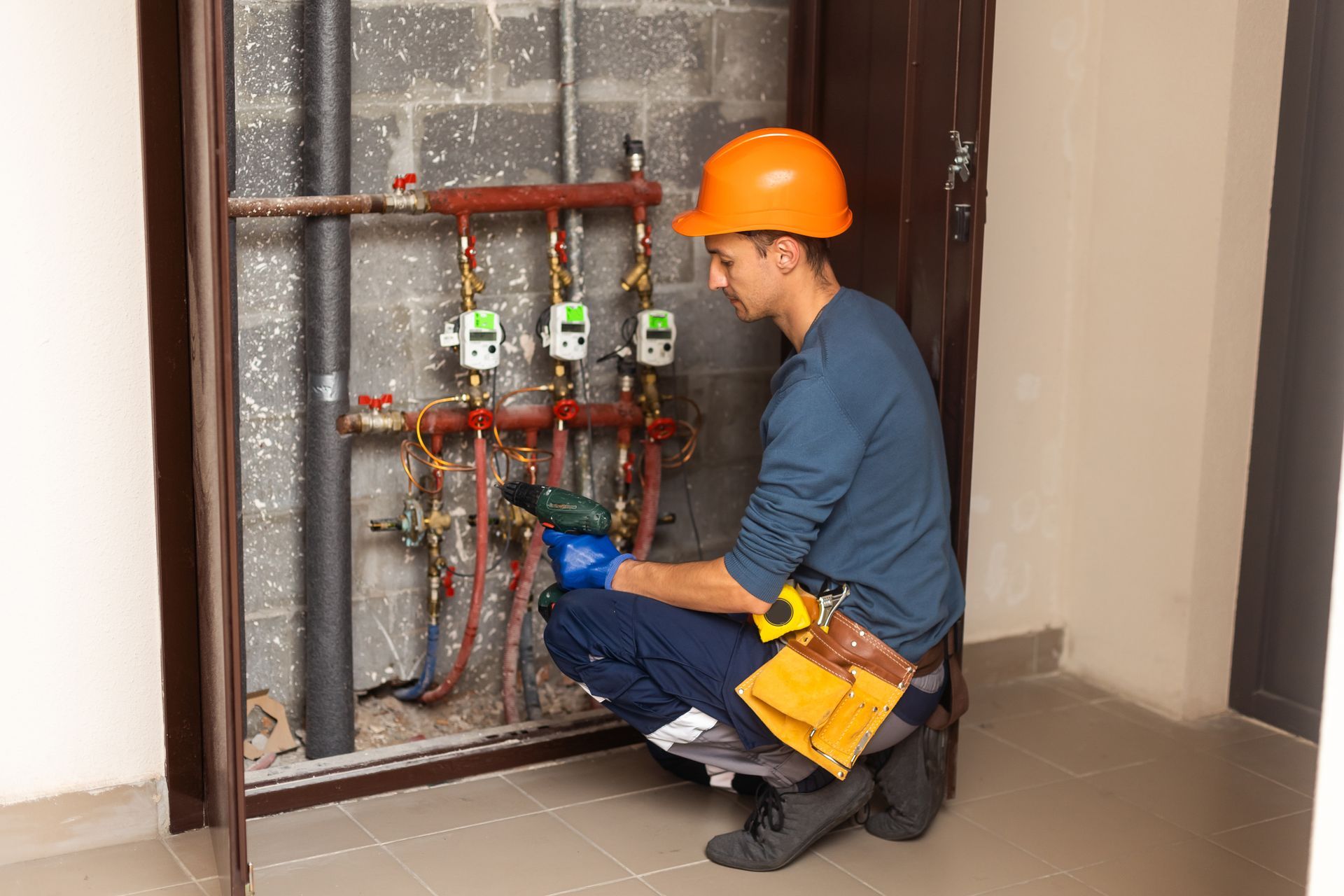 Technician inspecting circulation pumps for underfloor heating system.