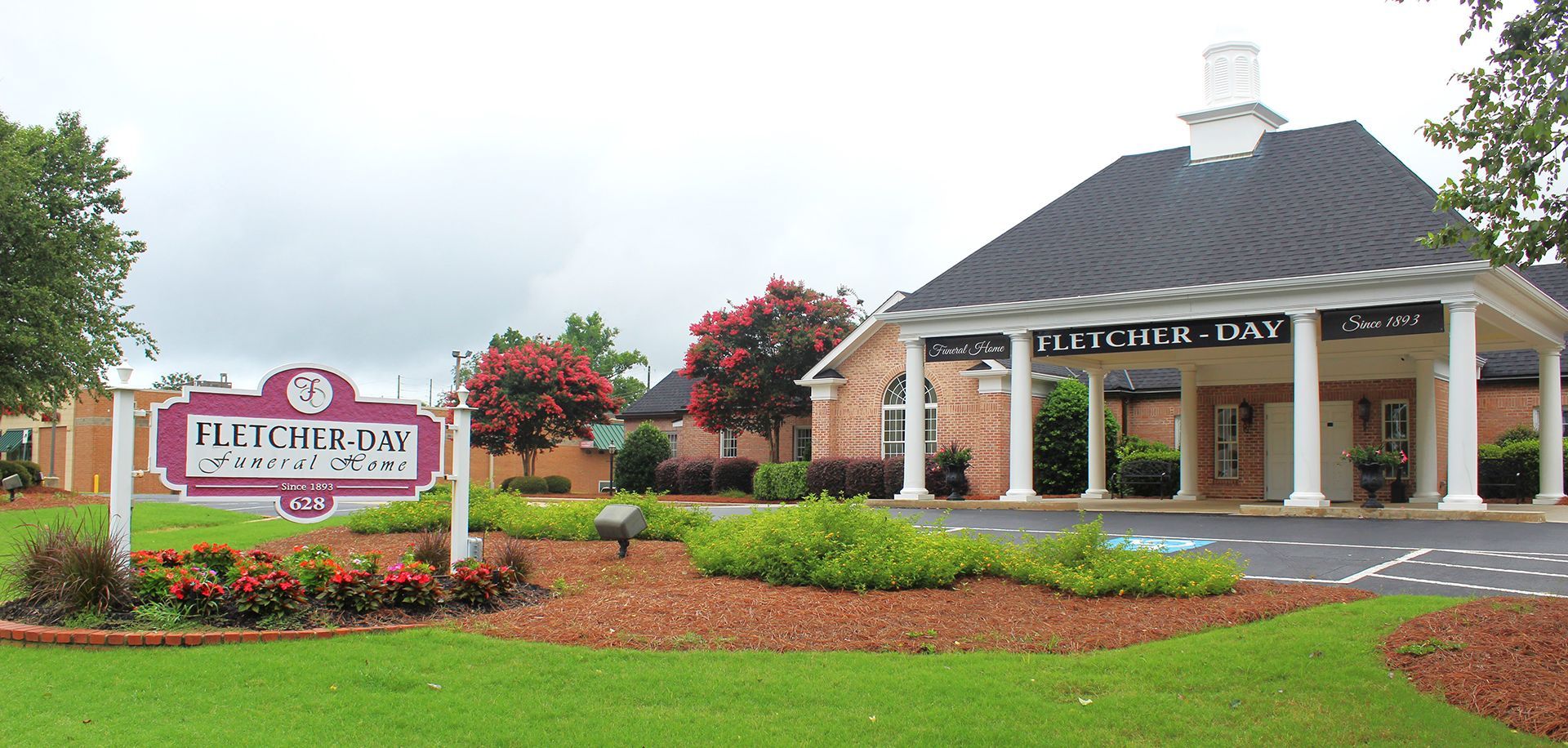 A large brick building with a sign that says let 's pray