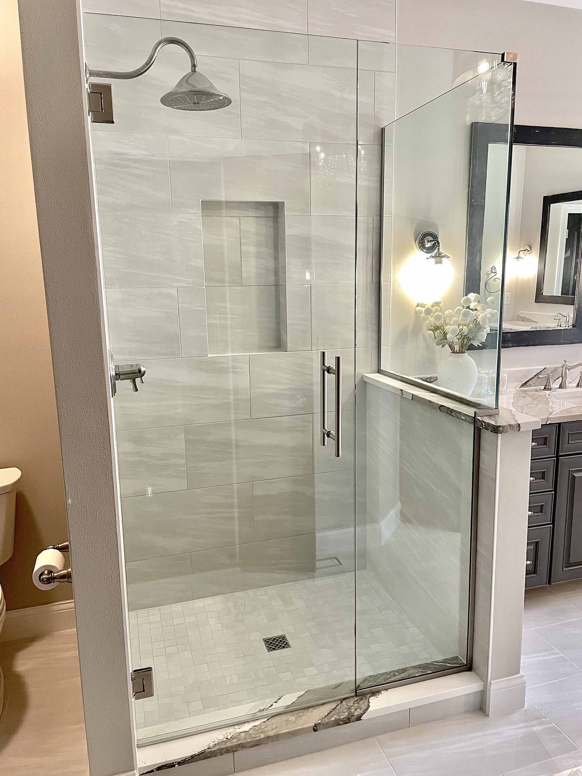A bathroom with a walk in shower and a toilet.