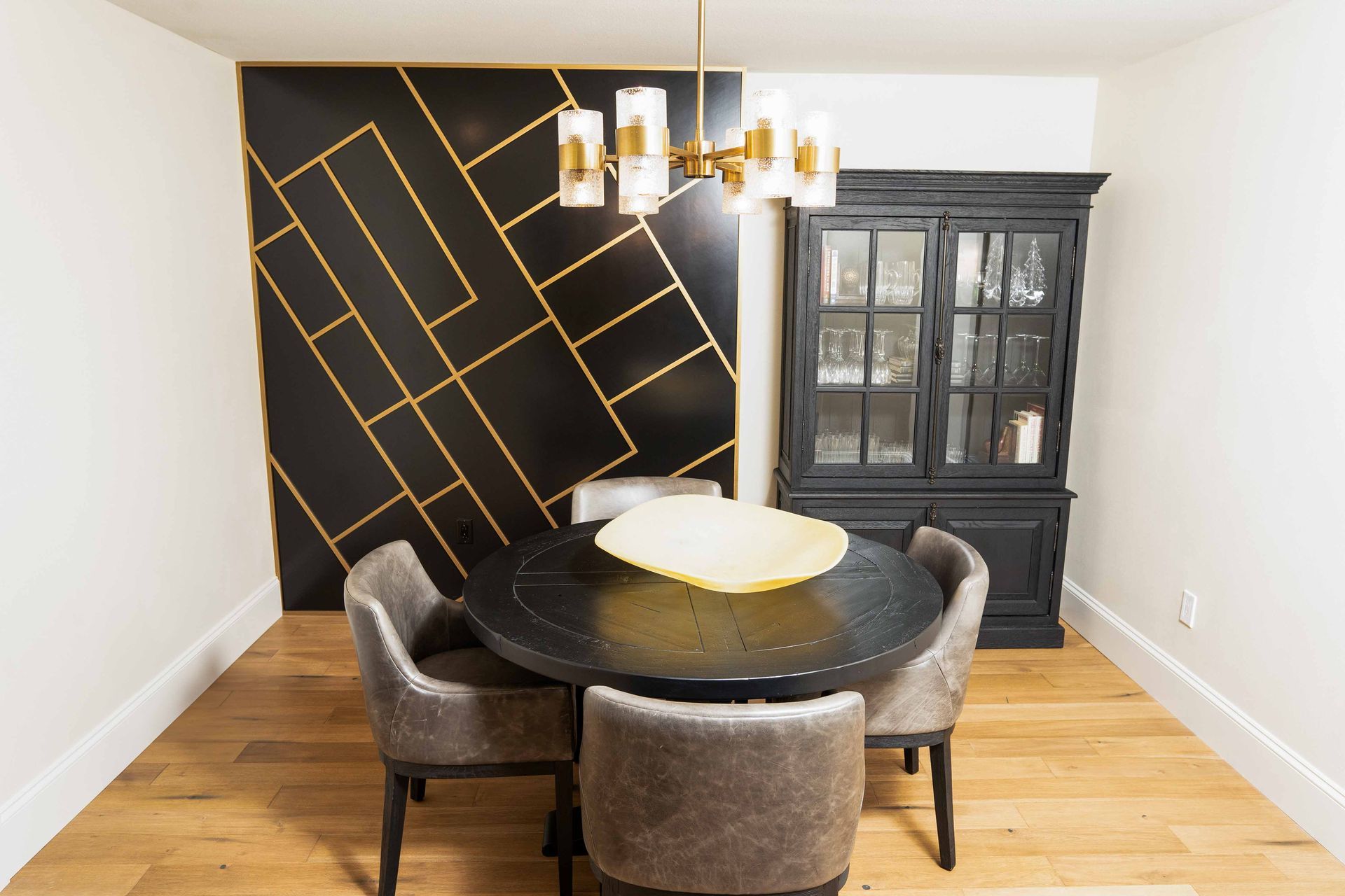 A dining room with a round table and chairs