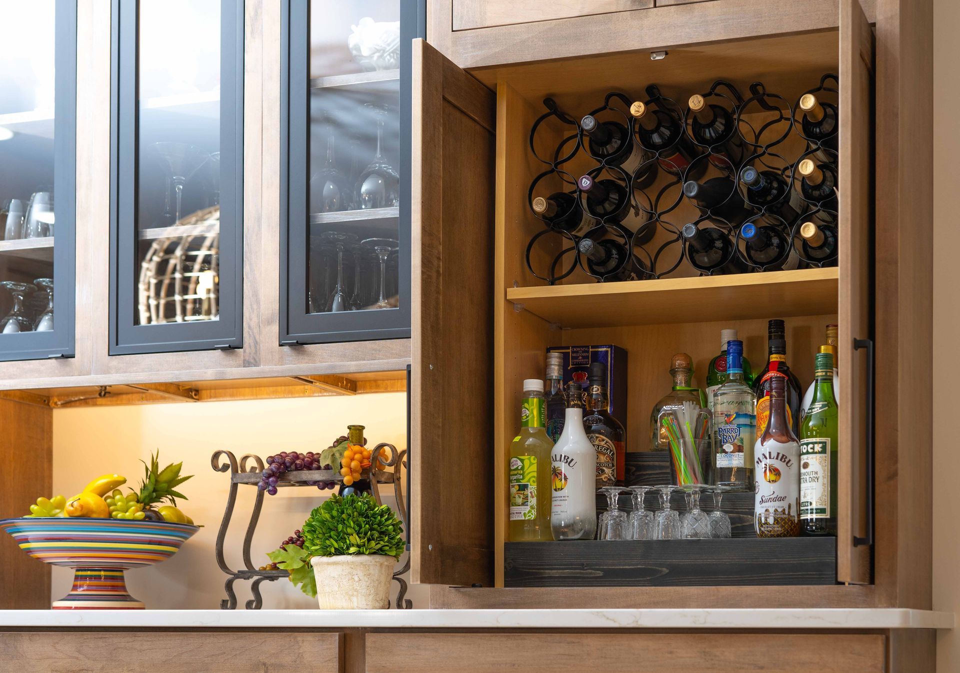 A kitchen with a wine rack and bottles of liquor.