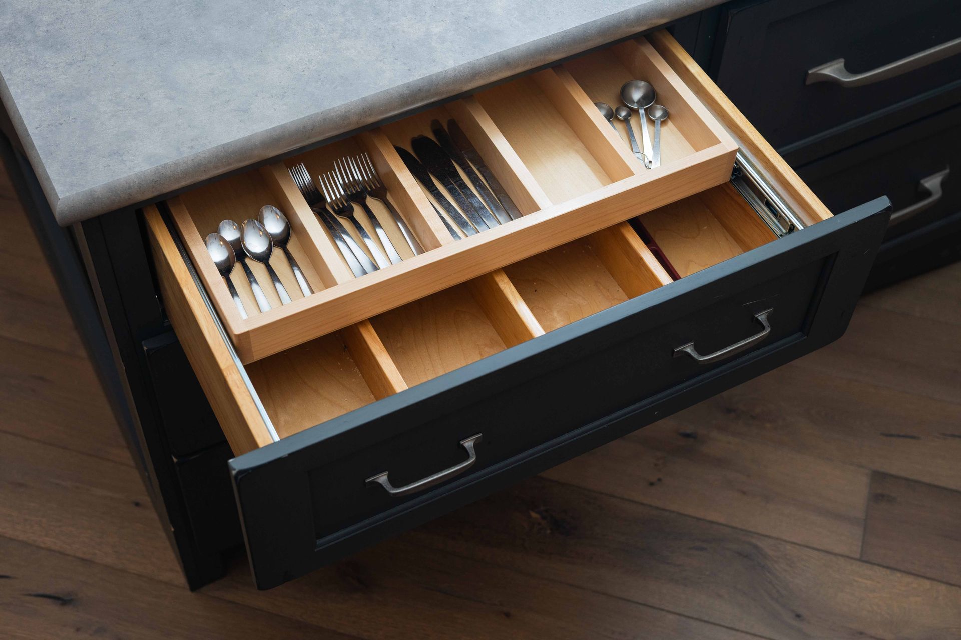 A kitchen drawer filled with silverware and utensils.