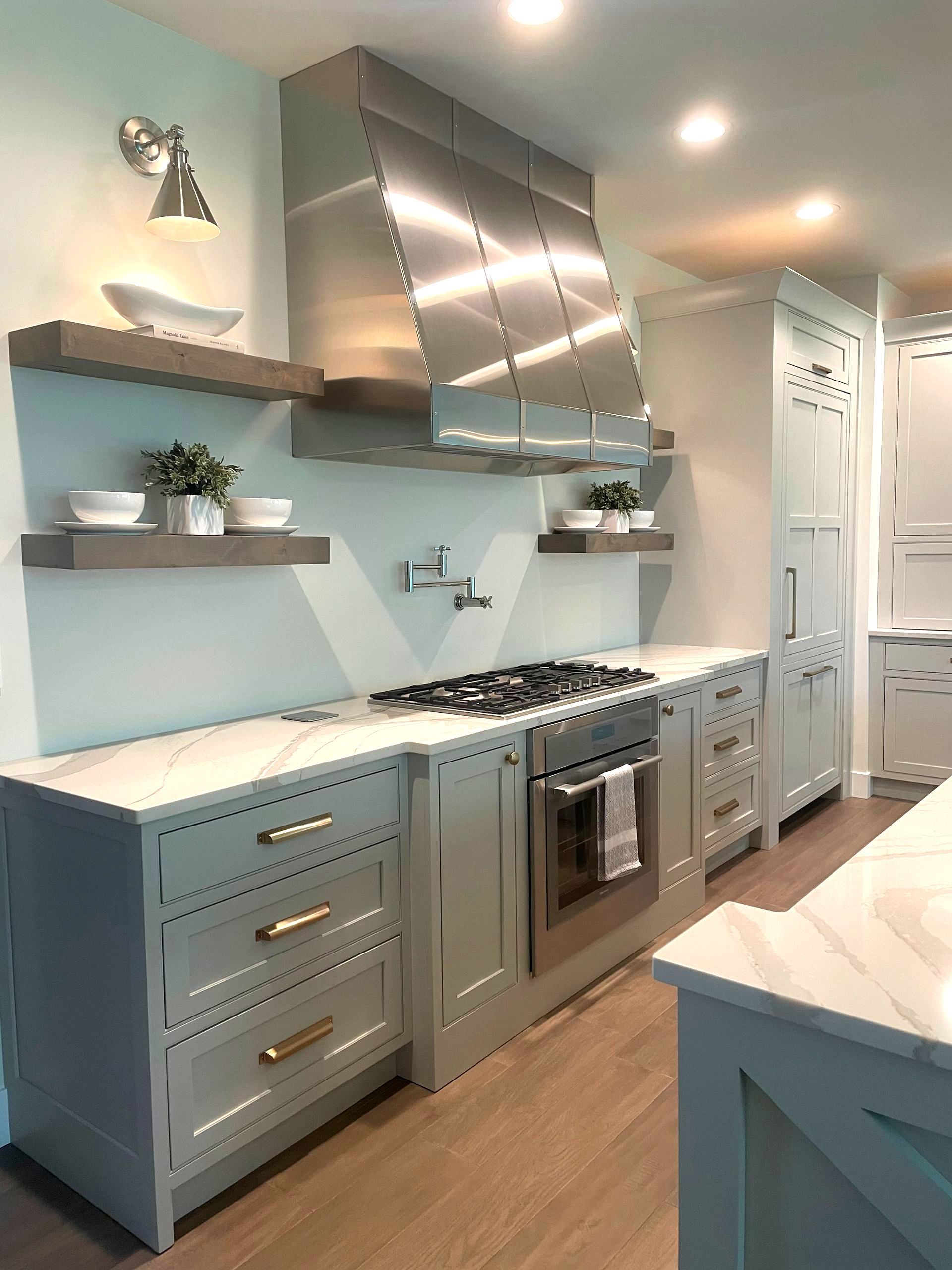 A kitchen with stainless steel appliances and white cabinets