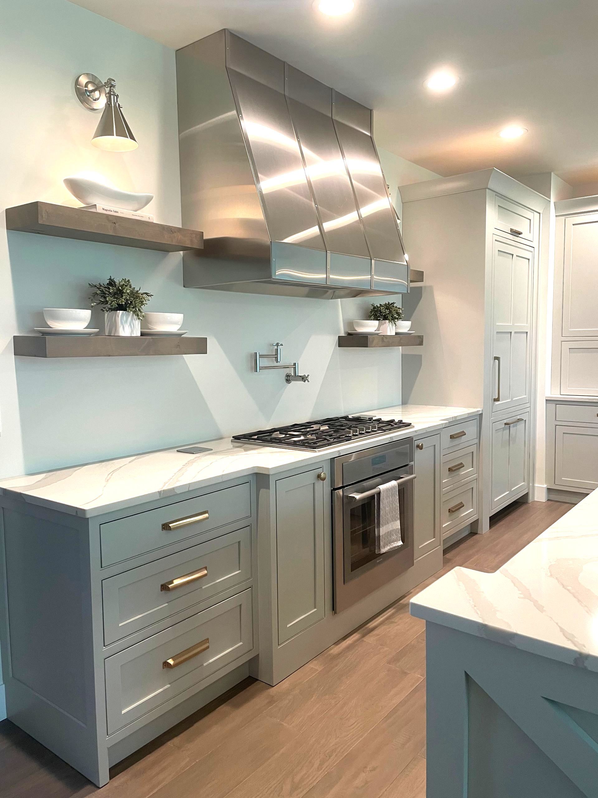 A kitchen with stainless steel appliances and white cabinets