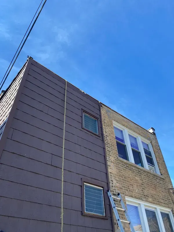 A ladder is attached to the side of a building.