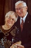 Portrait of Robert and Marilyn Schildmeyer in formal attire, woman in sparkly top, man in suit.