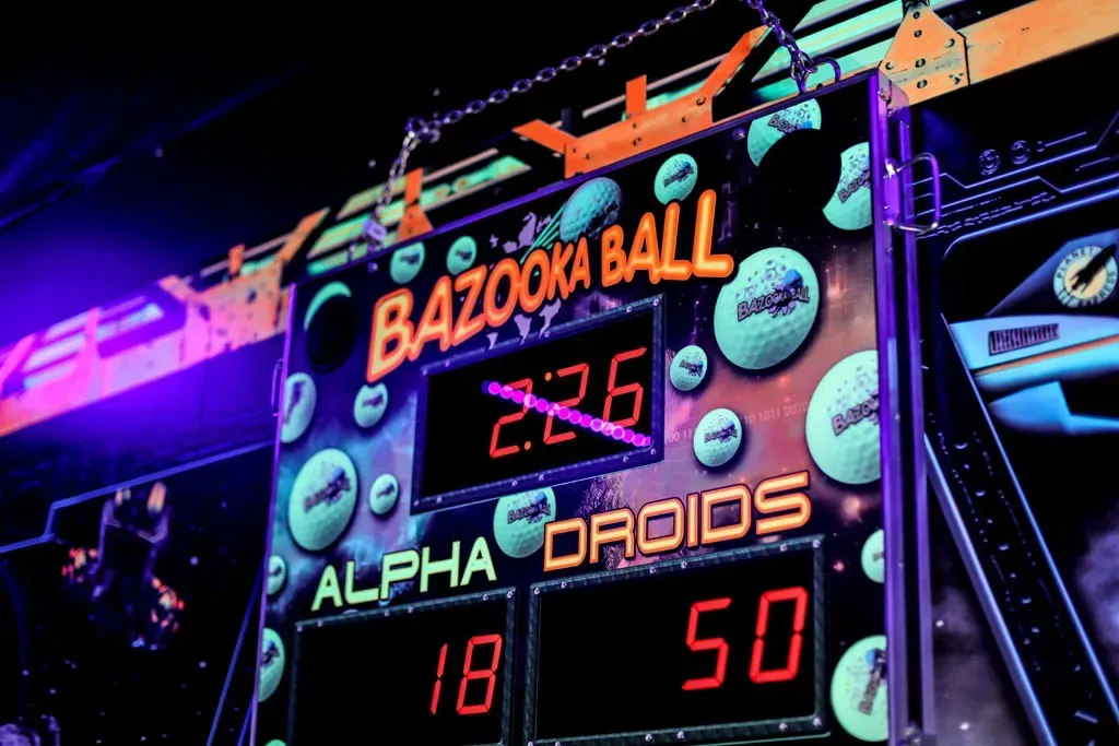 Bazooka Ball game scoreboard with Alpha Droids score: 18, other team 50. Digital display in orange.