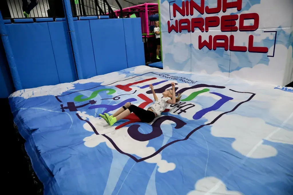 Person lies on mat below a 