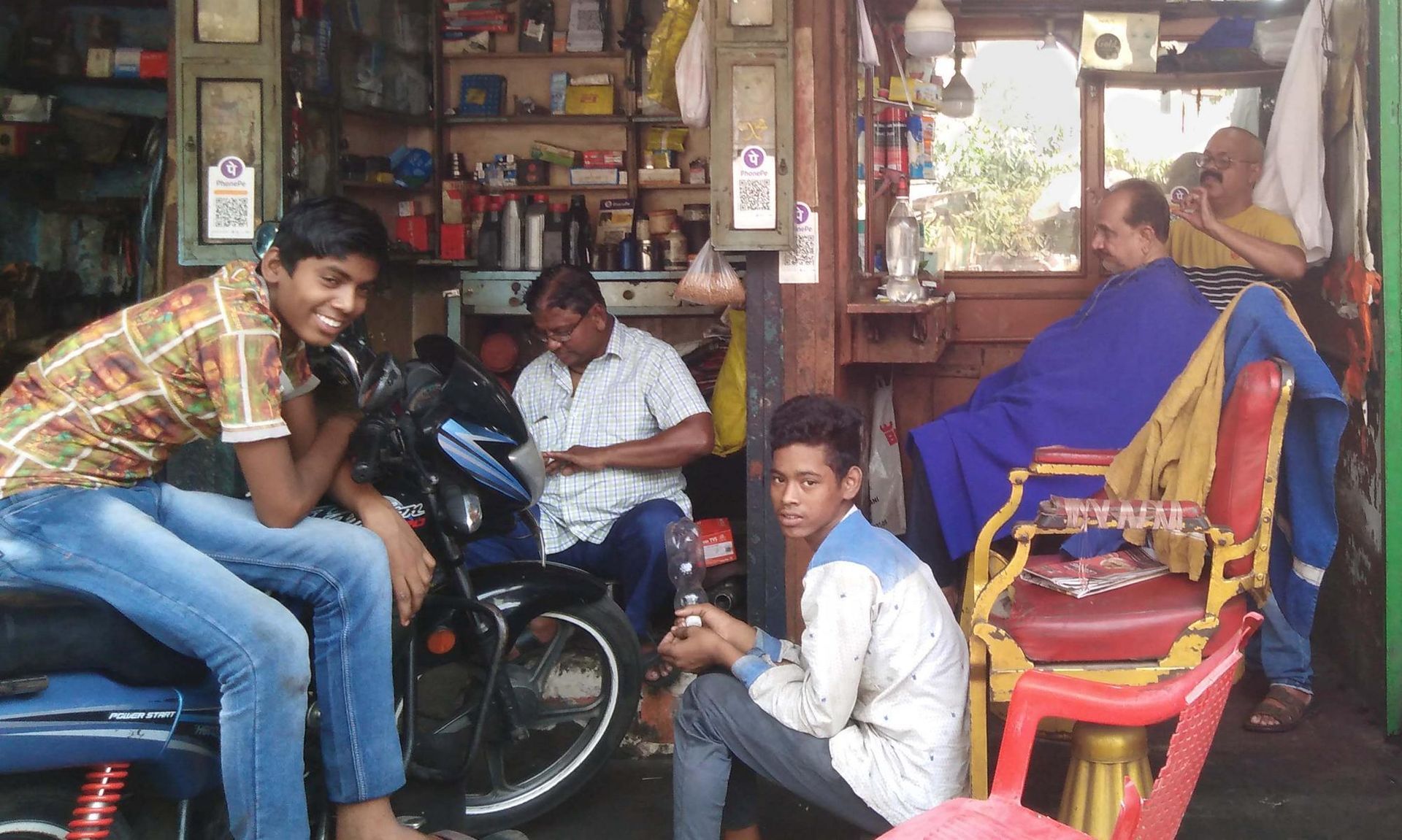 Blick in ein Frisörgeschäft in Kalkutta Burra Bazar Friseurstuhl Vintage Alt Antik Metall Gusseisen 