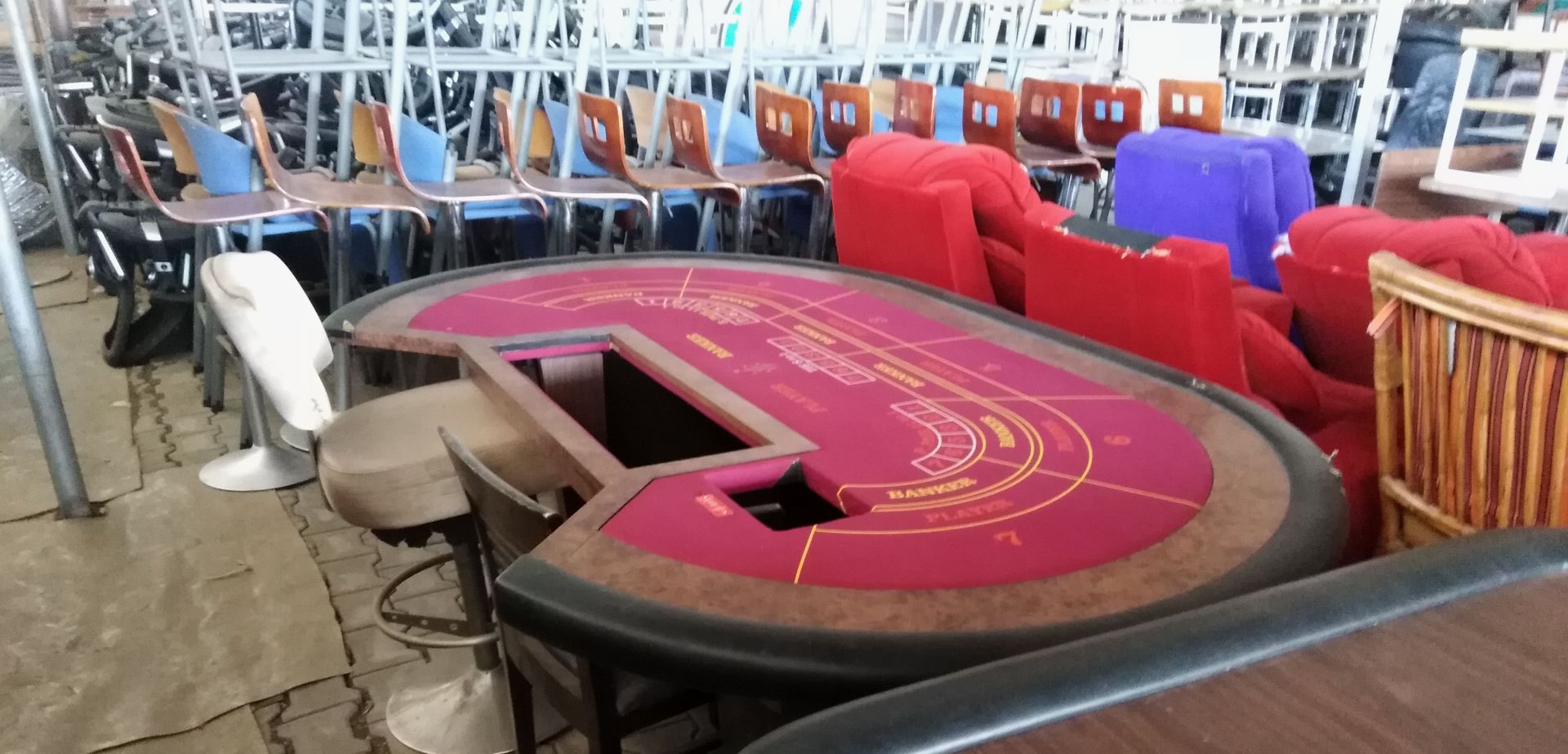 alter Spieltisch hinter dem Barhocker aus einem alten Schiffsrestaurant stehen.