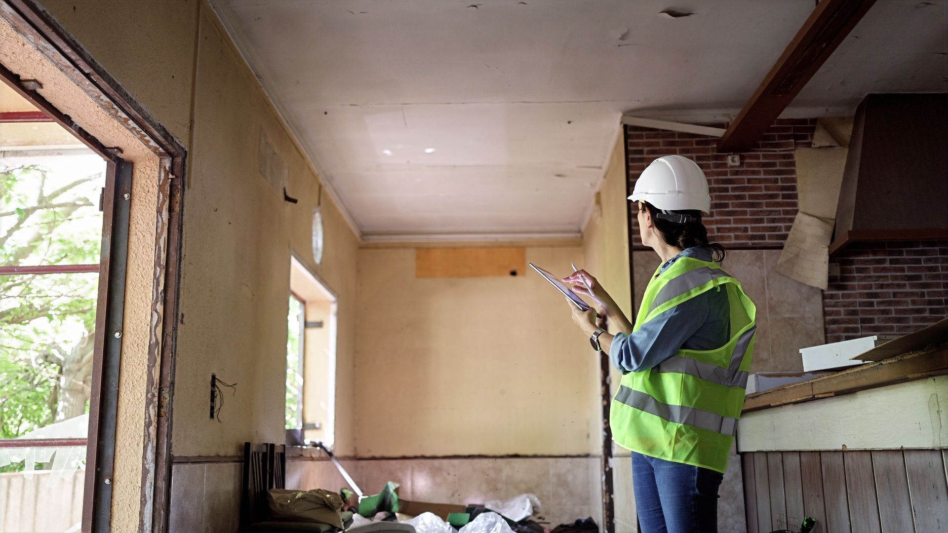 a construction worker inspecting an unfinished room.