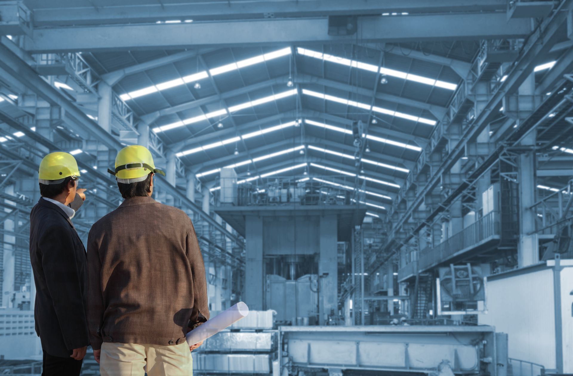 Two engineers are working in a commercial building with a steel structure.