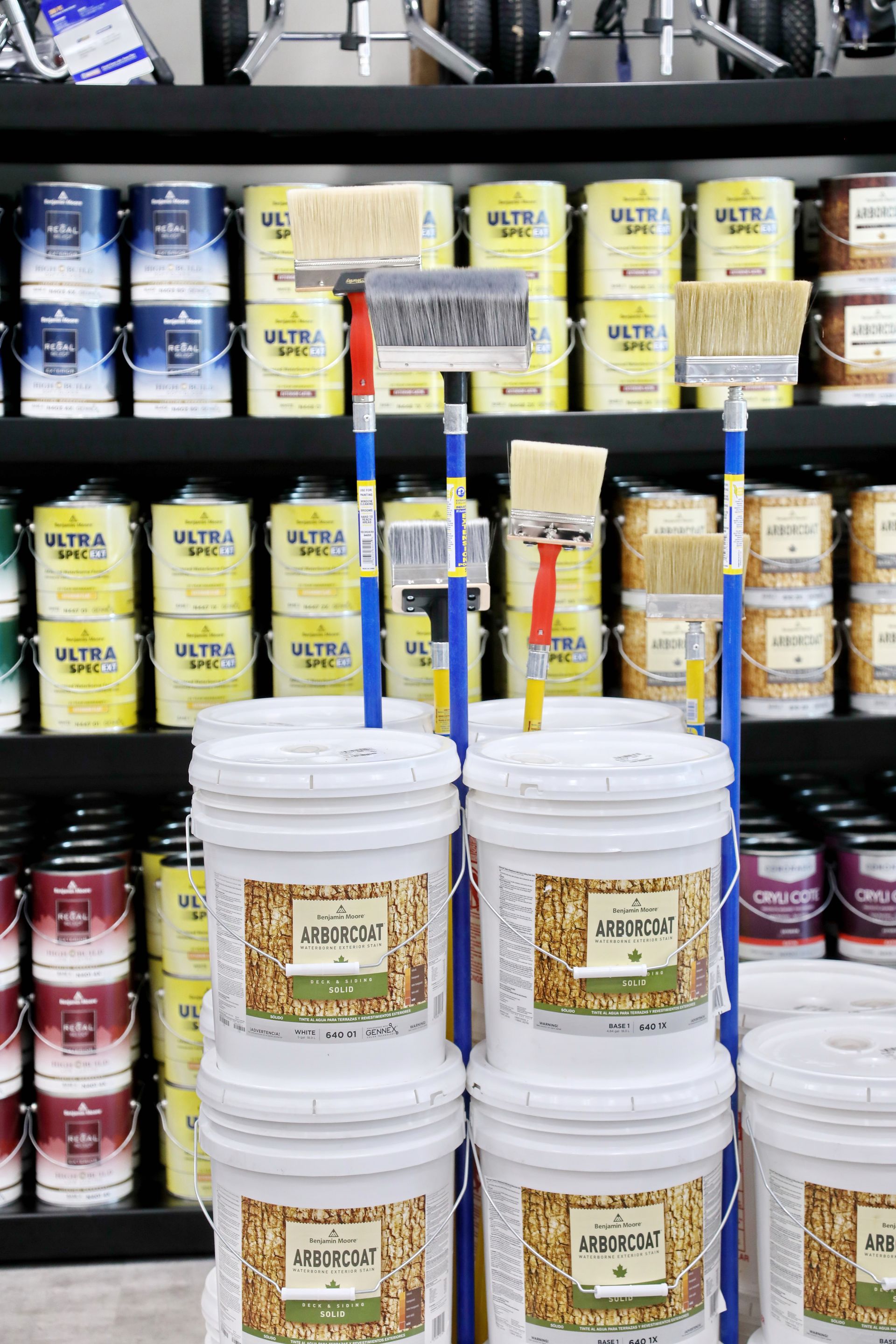 Buckets of paint are stacked on top of each other in a store.