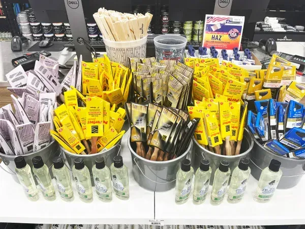 A table with buckets filled with different types of food and drinks.