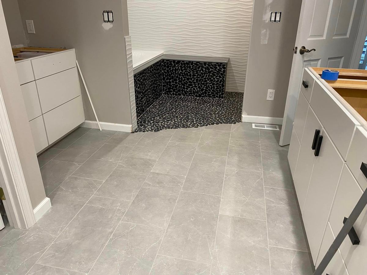 Kitchen with light gray tile floor and cabinets, centered on a built-in hearth or fireplace opening.
