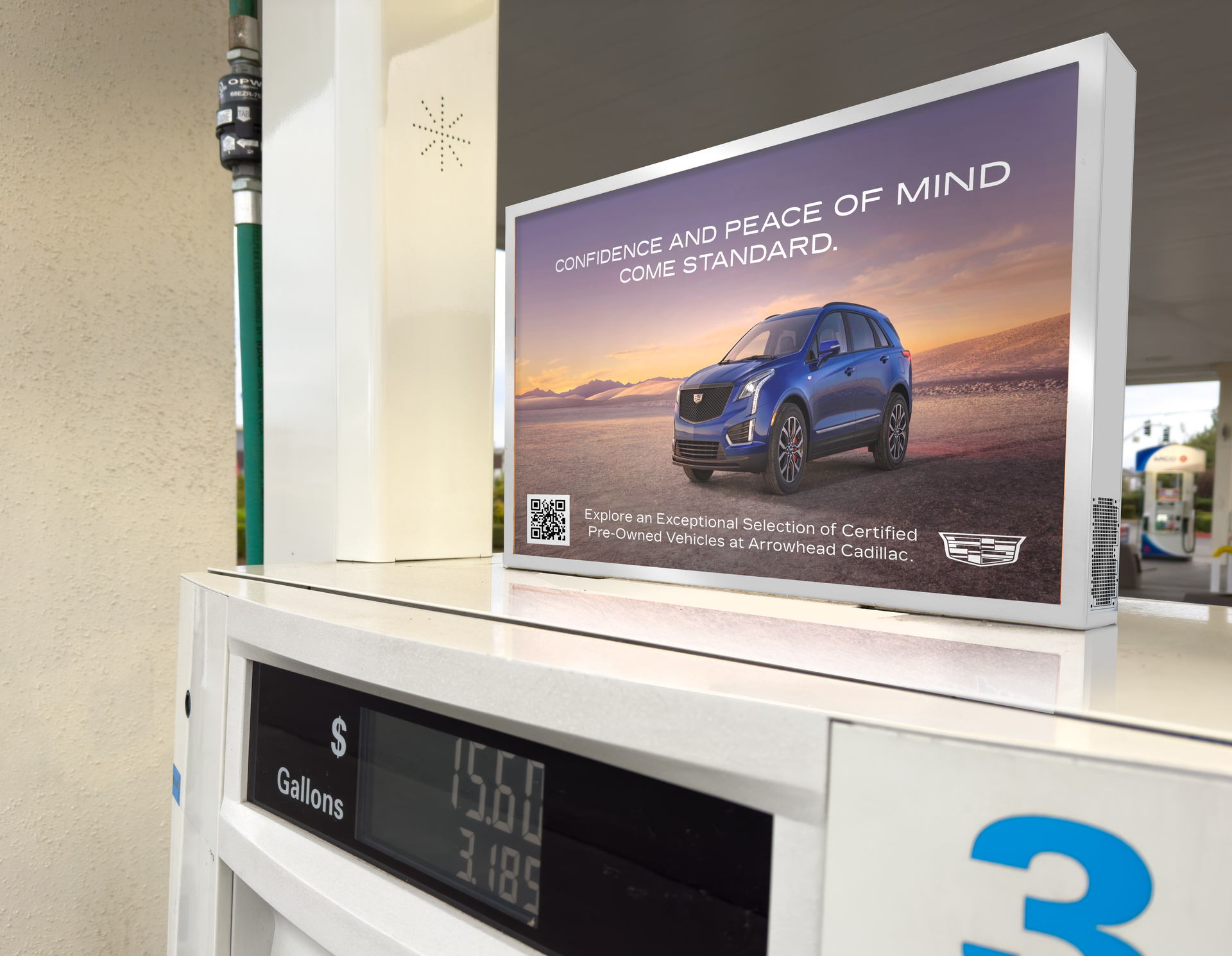 Blue SUV ad on a gas pump display showing a car at sunset with the slogan “the future of wind.”