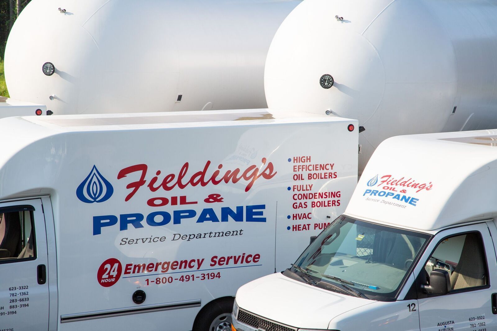 Fieldings Oil & Propane delivery trucks with white tank trailers in a lot