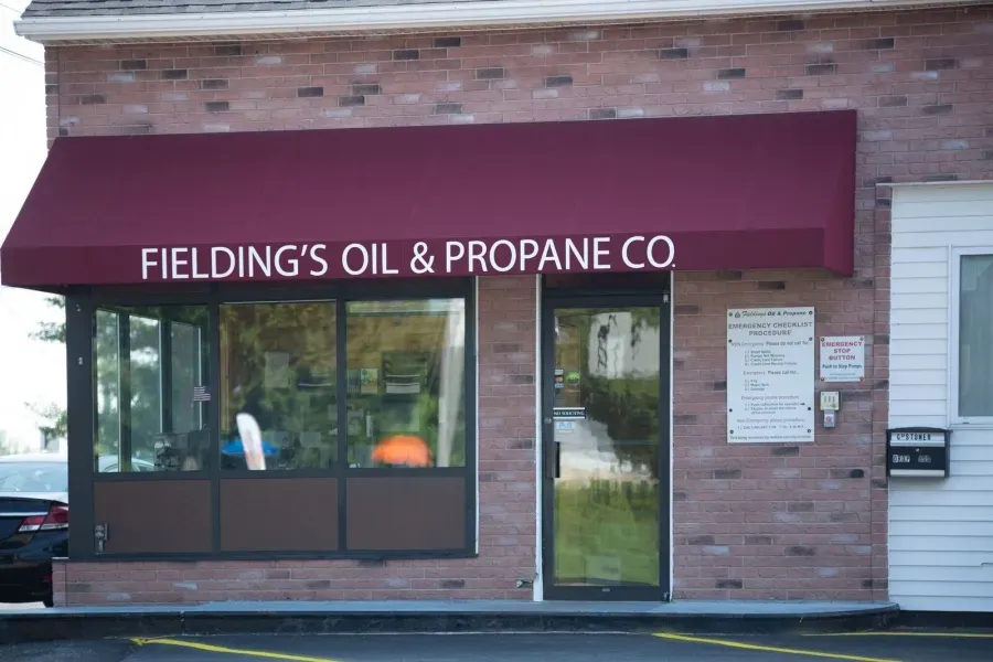Fielding’s Oil & Propane Co storefront with maroon awning and brick facade