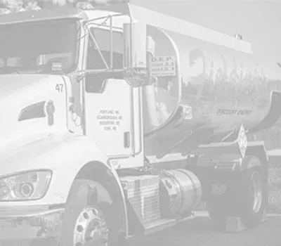 White fuel tanker truck parked outdoors, side view with company logo on the tank.