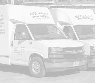 White delivery vans parked side by side in front of a building with Arabic signage