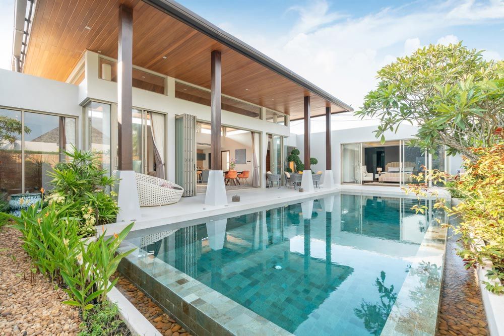 A Large House With a Swimming Pool in Front of It — Peterson Property Valuations In Caloundra West, QLD