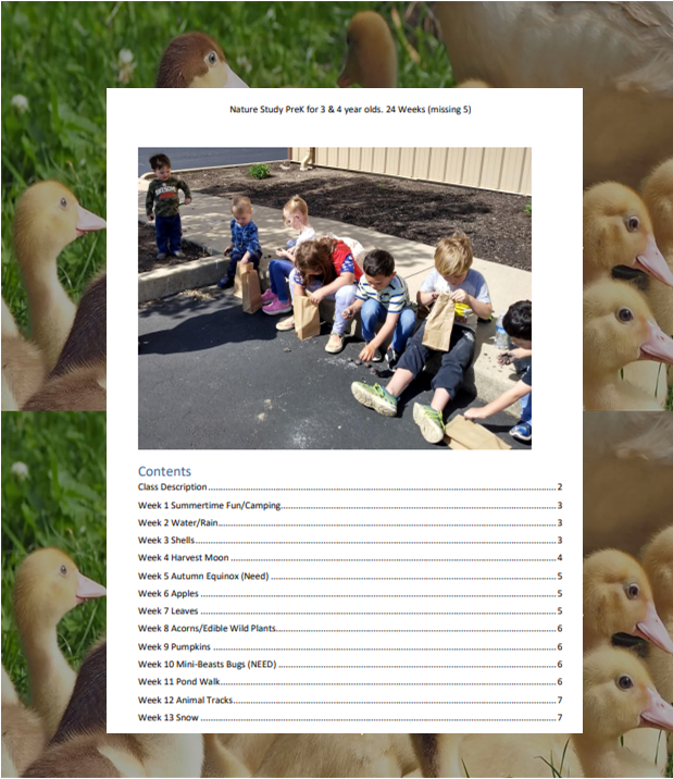 Children sitting on a sidewalk, looking at a book or worksheet outdoors.