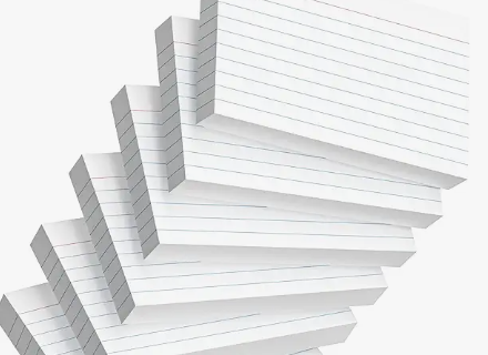 Stack of white lined papers fanned diagonally on a light gray background