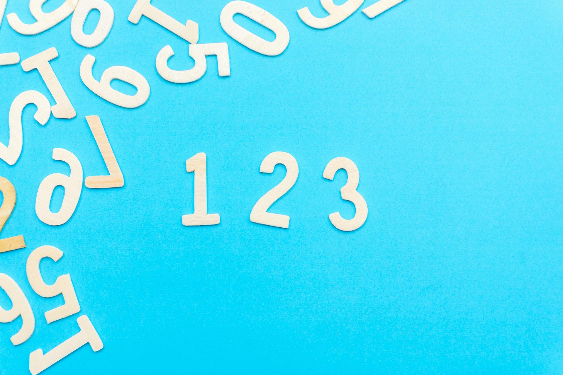White numbers on a blue background with scattered digits along the left edge