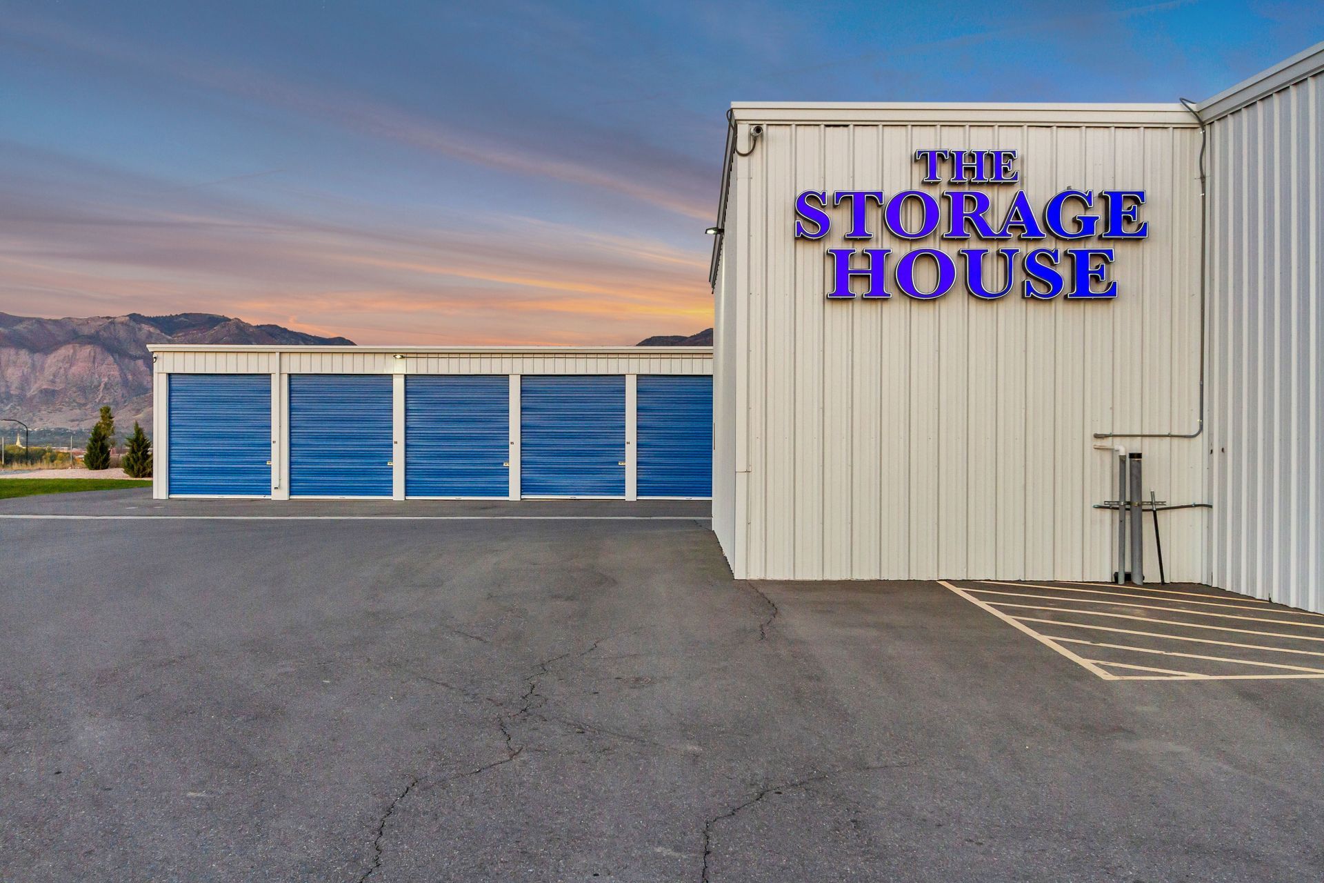 Storage facility exterior with blue doors and sign 