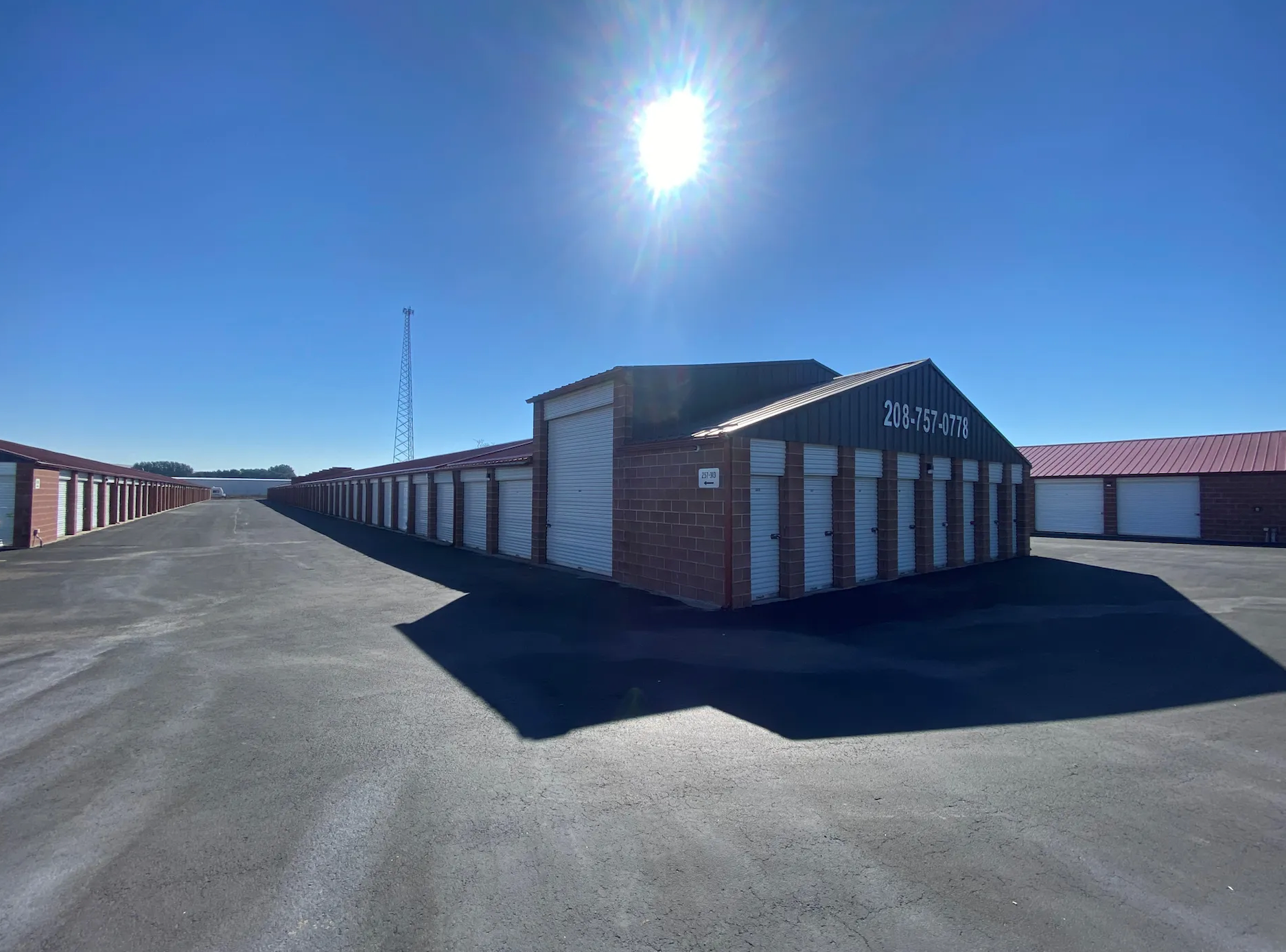 Storage units under a bright sun on a clear day.