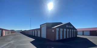Storage units on a sunny day. Brick and white buildings with the sun overhead.
