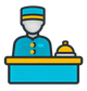 Blue hotel concierge behind a desk with a service bell