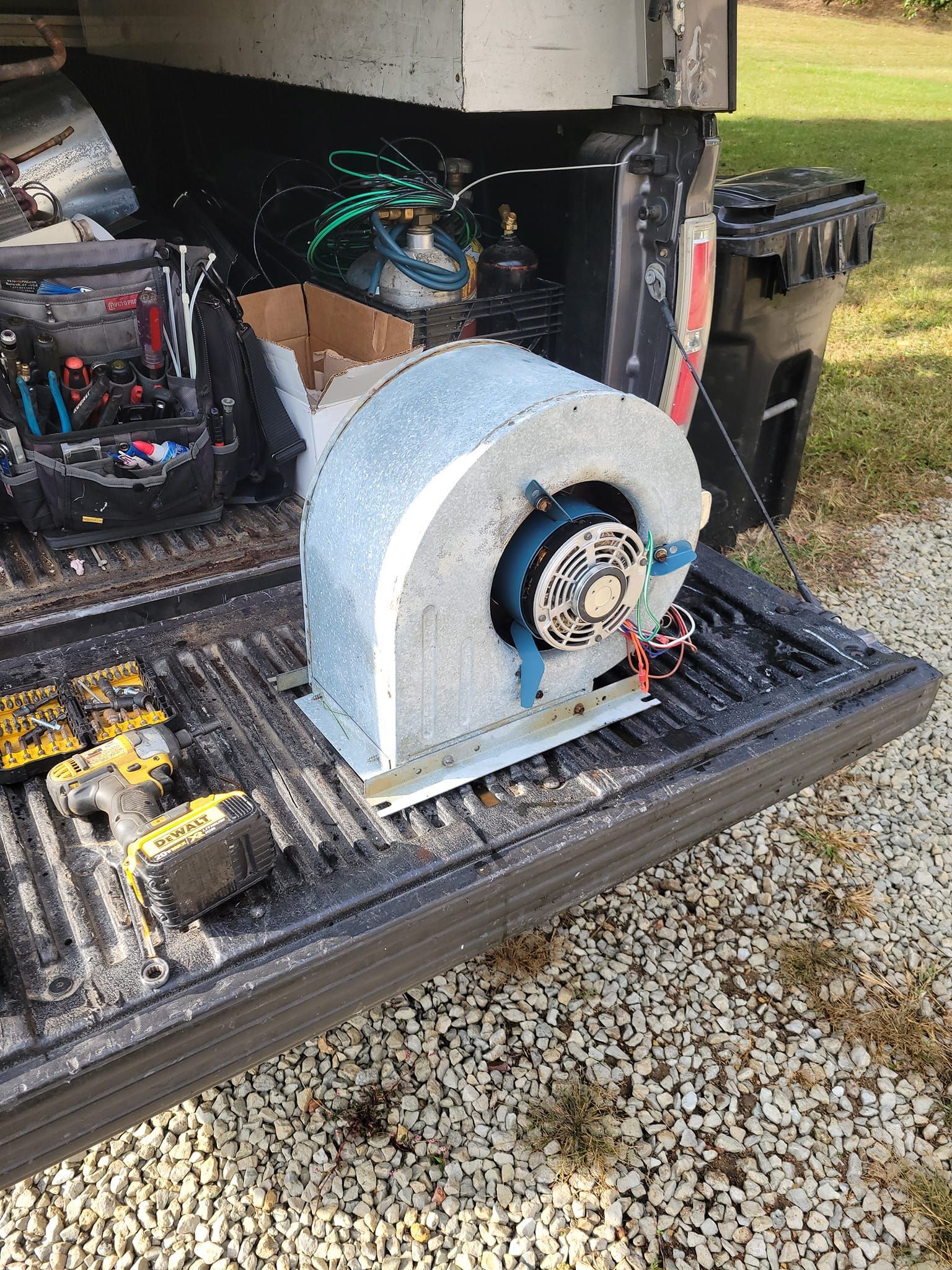A fan is sitting in the back of a truck.