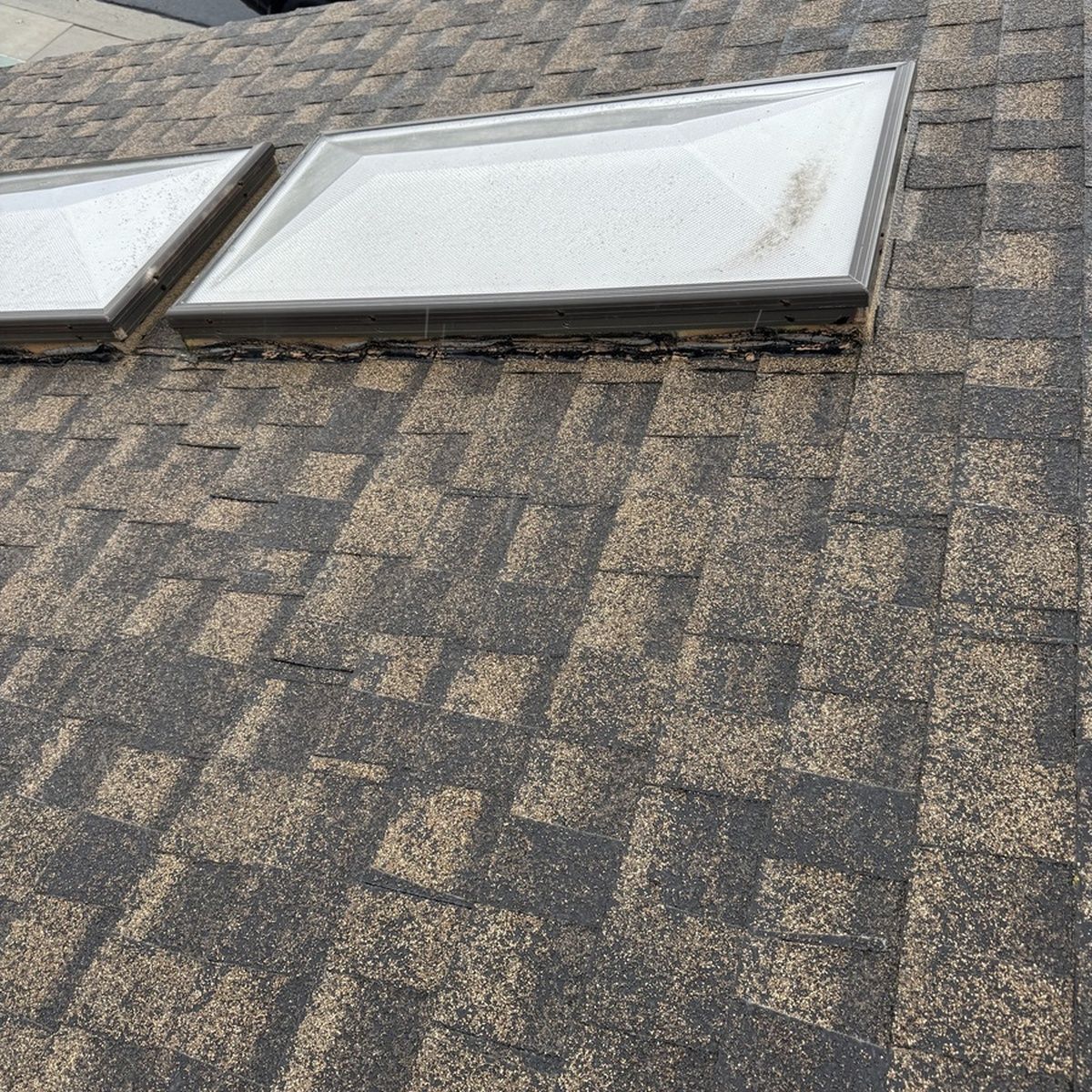 Roof shingles with two white skylights