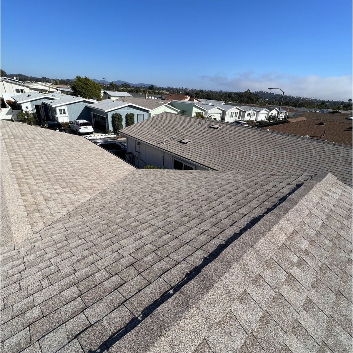 Rooftop view of a residential neighborhood under a clear blue sky