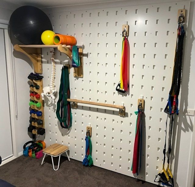 A wall with a bunch of exercise equipment on it