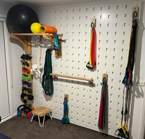 A wall with a bunch of exercise equipment on it