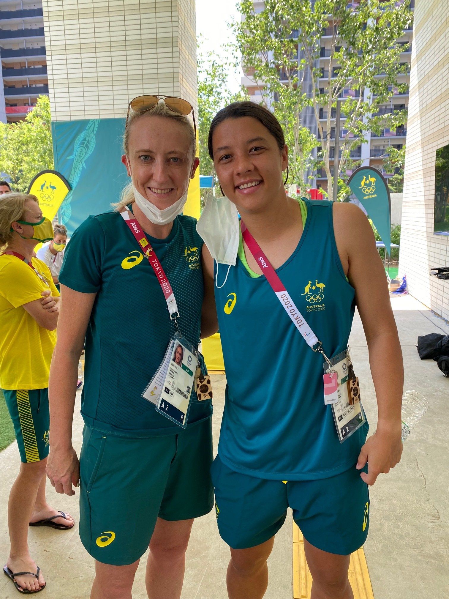Two women wearing masks are posing for a picture together.