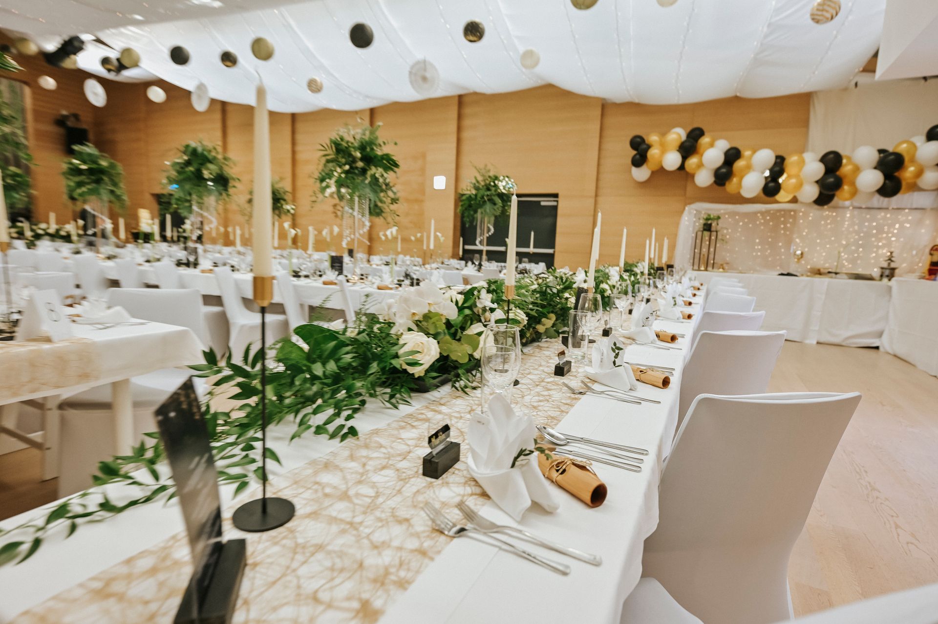Ein großer Raum mit Tischen und Stühlen für einen Hochzeitsempfang.