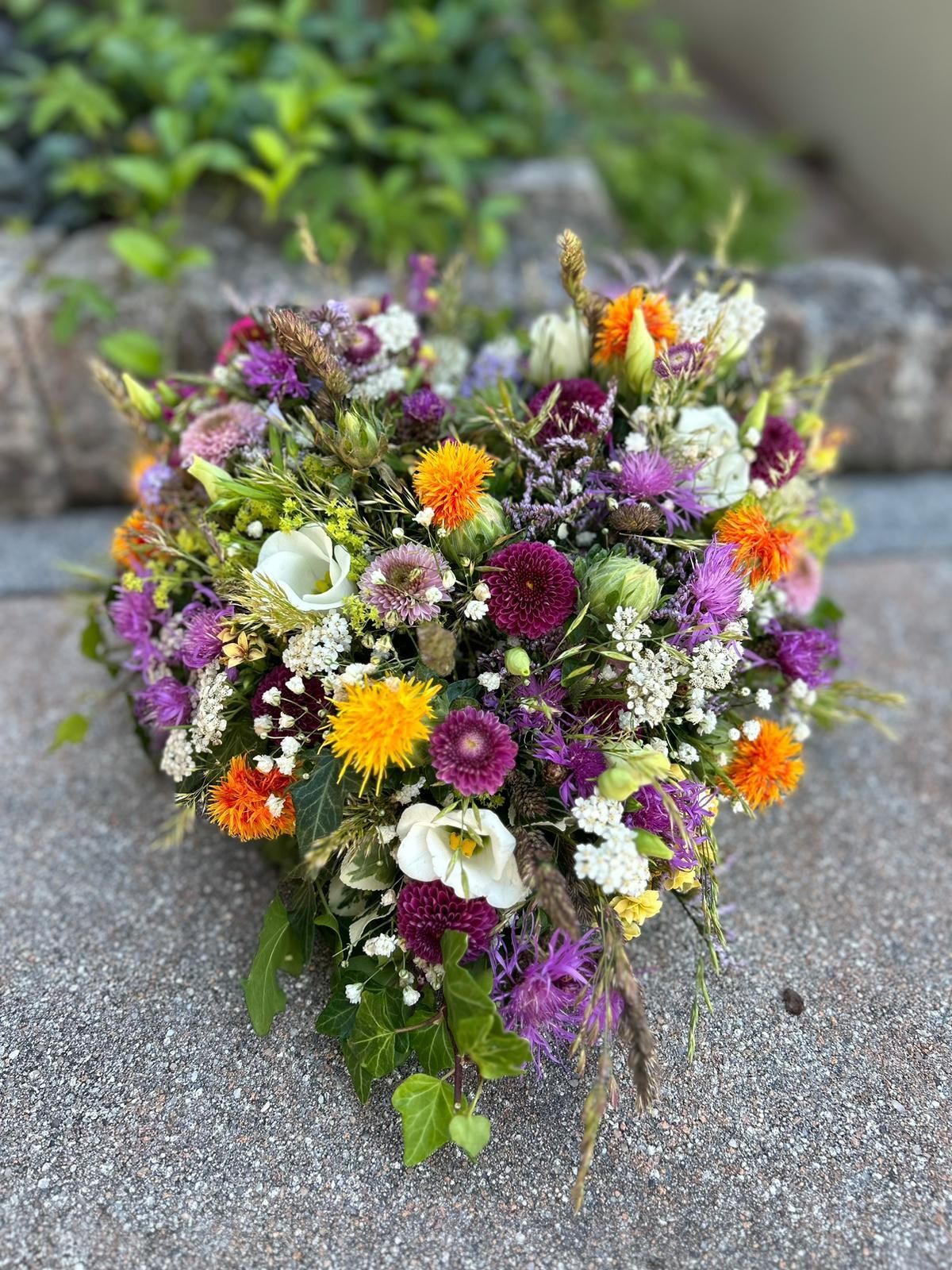 Auf dem Boden liegt ein herzförmiger Blumenstrauß.