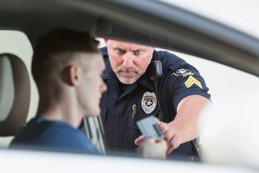A police officer is talking to a man in a car