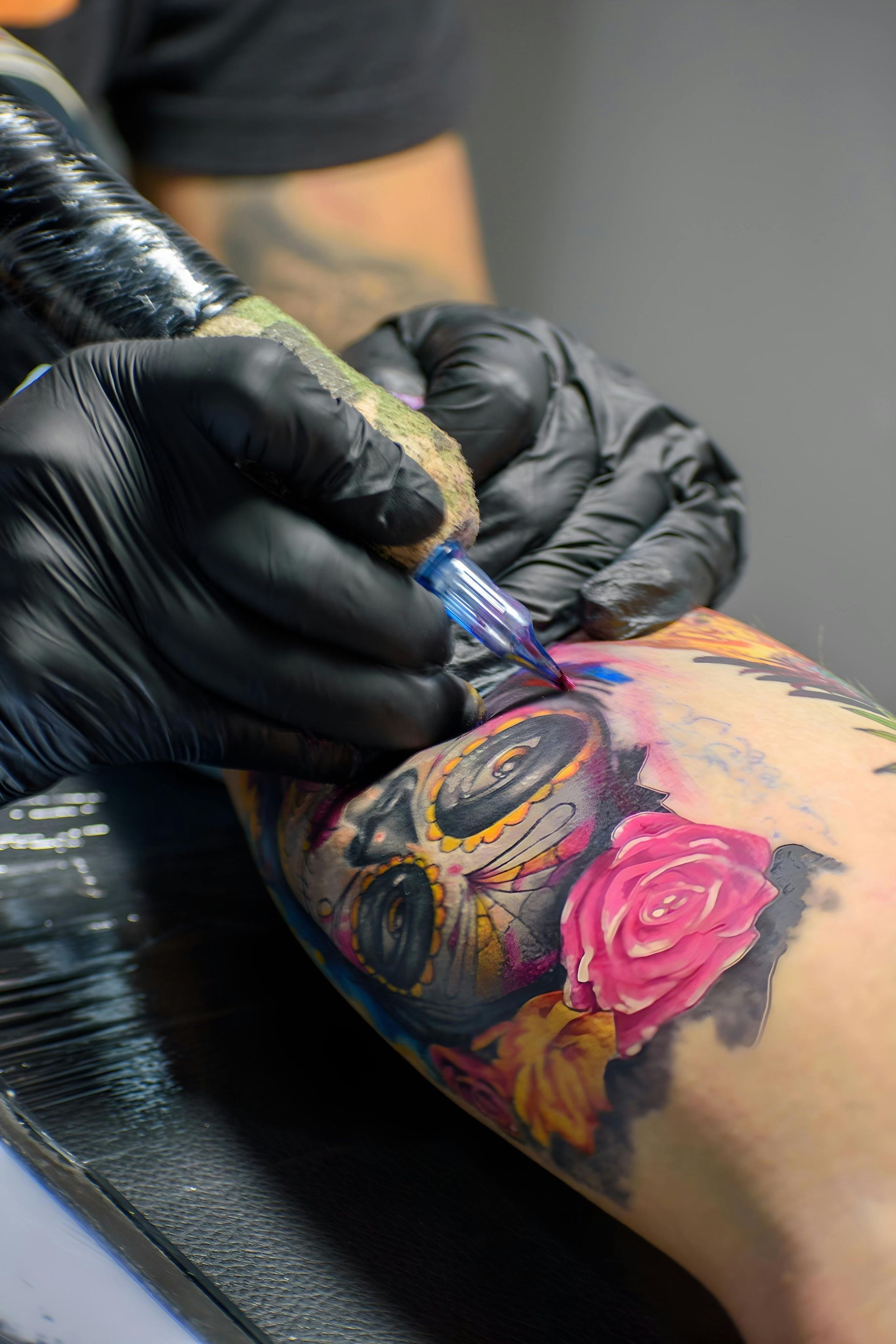 Tattoo Artist in Black Gloves — Laserpro Tattoo Removal in Shellharbour, NSW
