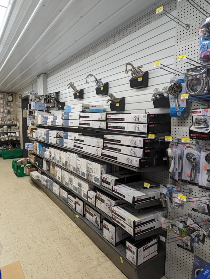 A store filled with lots of shelves and boxes of faucets.