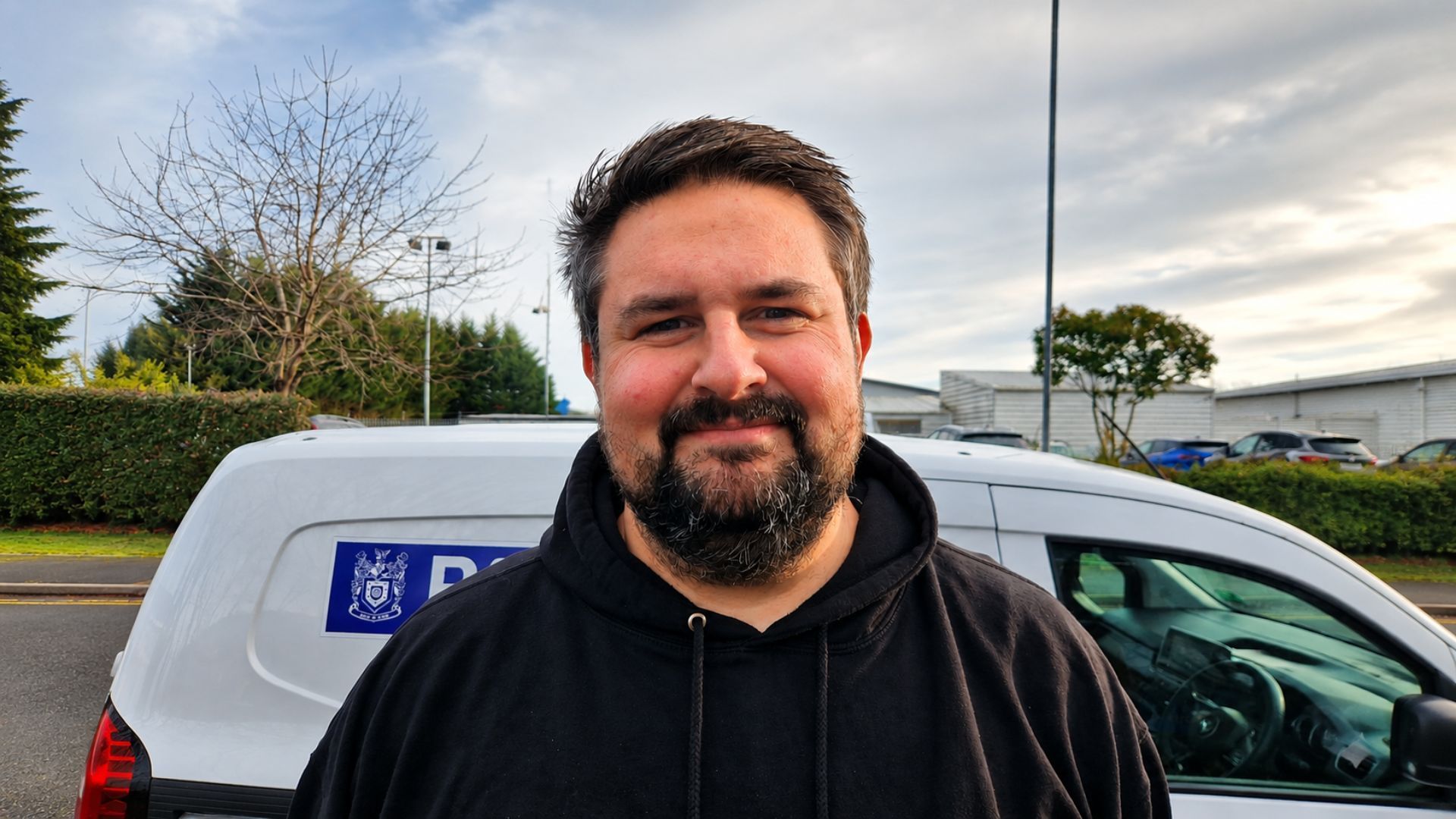 PatrolGuard Managing Director, Gareth Surdo, smiling in front of a PatrolGuard van.
