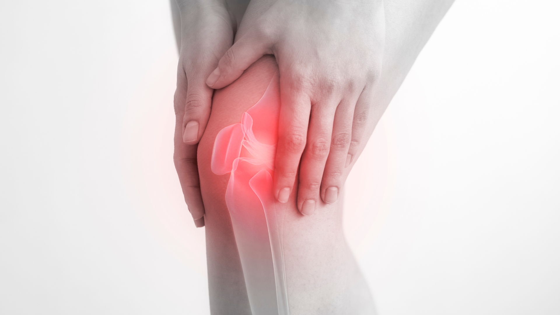 A person is holding their knee in pain.