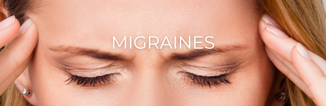 A woman is holding her head in pain because of migraines.